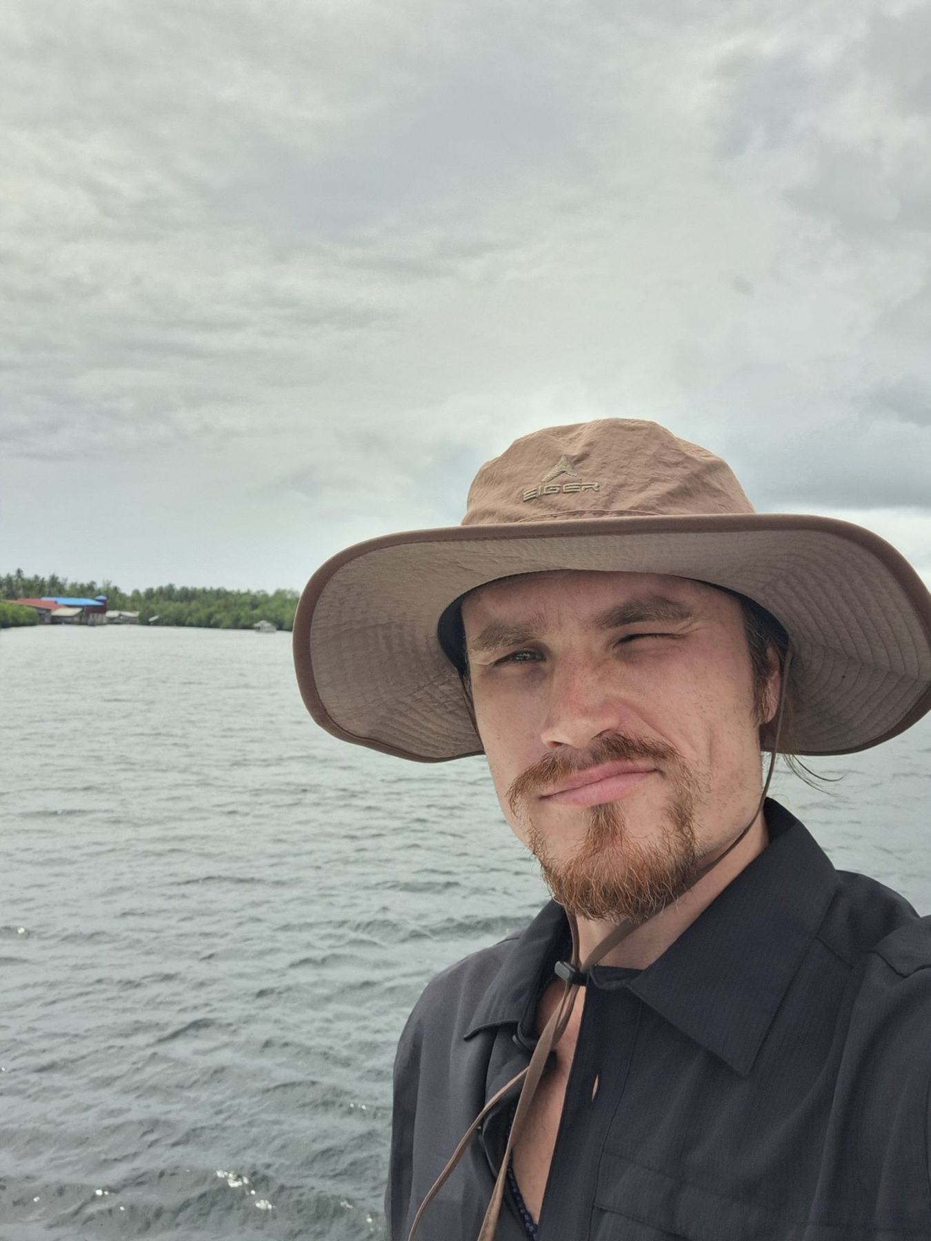 Portrait of Igor Mikhaylov in a wide-brimmed hat, on the water
